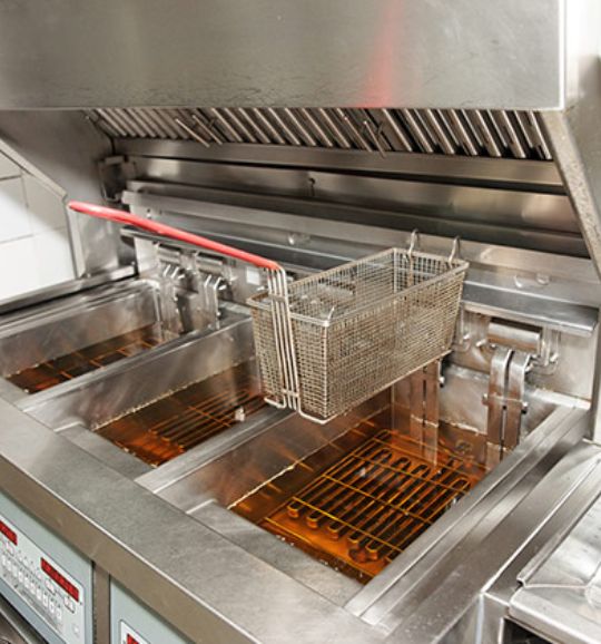 A two-basket commercial fryer, showcasing its design, with a note on repair services in San Antonio, TX.